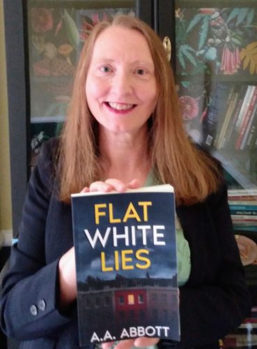AA Abbott with psychological thriller Flat White Lies and bookshelves in background